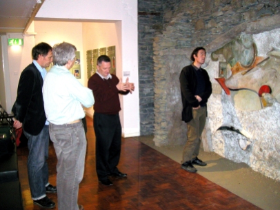Adam Lowe of Factum Arte, Madrid, examining the original Merz Barn wall in the Hatton Gallery, April 2007.