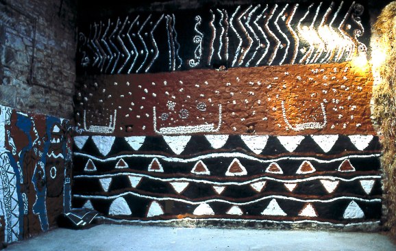 Toro's barn was plastered with cow dung in the traditional Nigerian style, painted, and inset with cowrie shells.