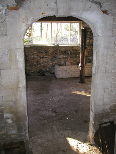 Inside the Merz Barn, looking from the Cake Room. (the drain pipes happened to be there, and were set up to show approximately where Schwitters had planned to erect a pillar sculpture).