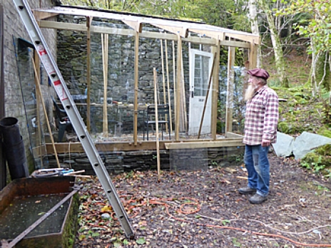Steve Grundy with his glasshouse